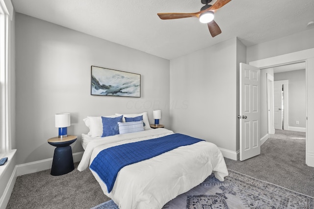 carpeted bedroom featuring ceiling fan and a textured ceiling