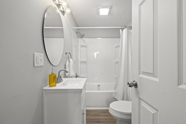 full bathroom with a textured ceiling, toilet, vanity, shower / tub combo, and hardwood / wood-style flooring