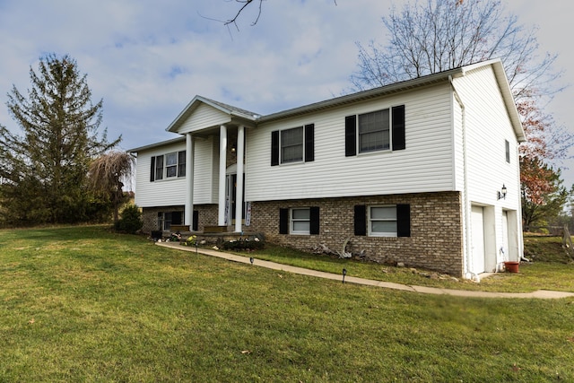 raised ranch with a garage and a front lawn