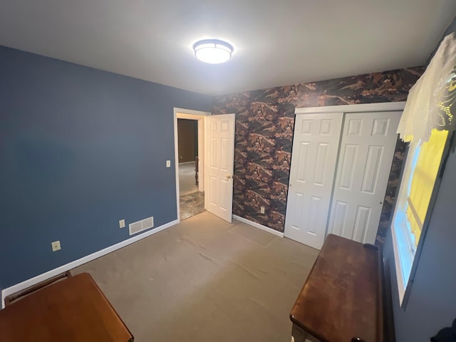 unfurnished bedroom with carpet floors and a closet