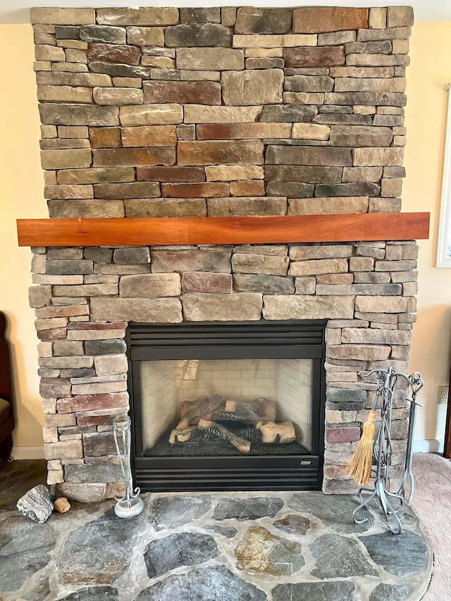 interior details featuring a stone fireplace