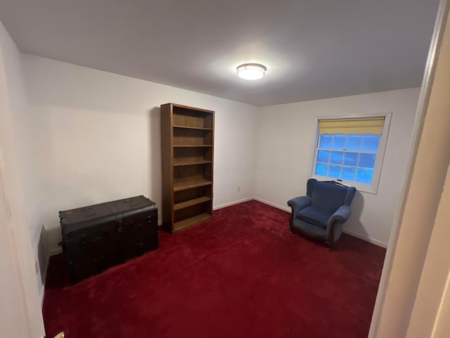 living area with dark carpet