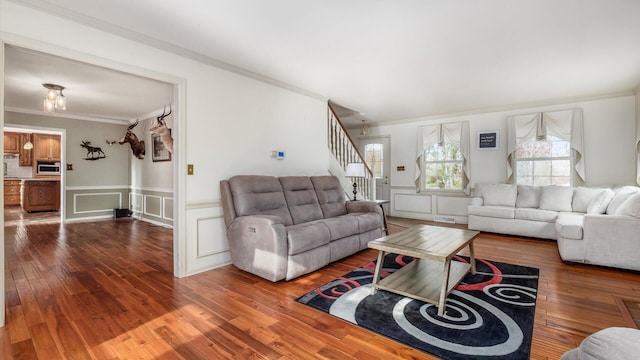 living room with hardwood / wood-style floors and crown molding