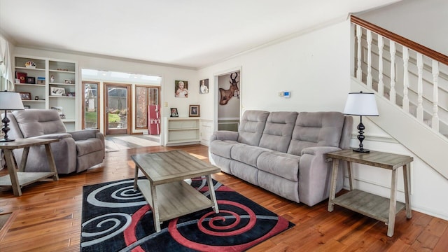 living room featuring hardwood / wood-style floors and crown molding