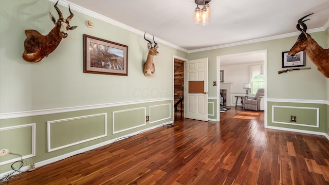 interior space featuring crown molding and dark hardwood / wood-style flooring