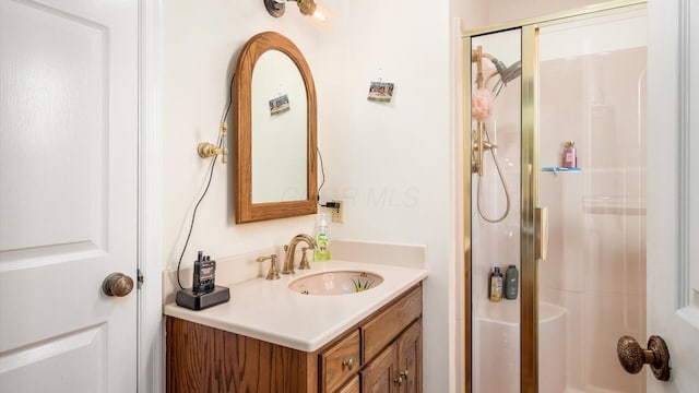 bathroom featuring vanity and an enclosed shower