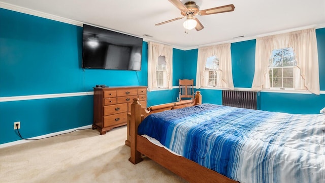 bedroom featuring ceiling fan, ornamental molding, and light carpet