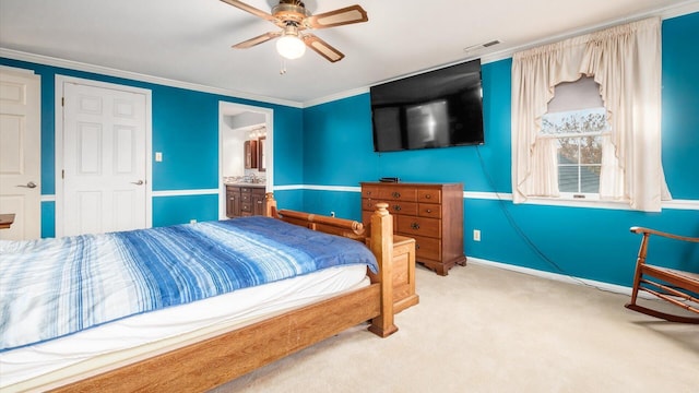 carpeted bedroom featuring ceiling fan, crown molding, and ensuite bathroom