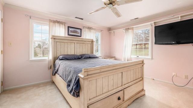 carpeted bedroom featuring multiple windows, ceiling fan, and ornamental molding