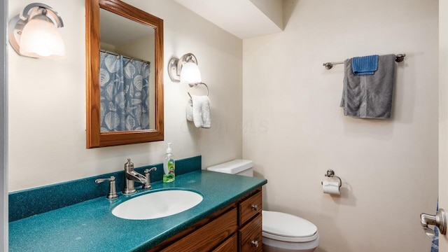 bathroom featuring vanity and toilet