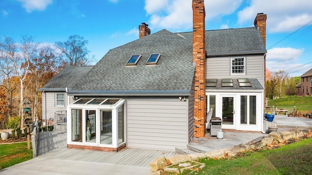 back of house with french doors and a deck