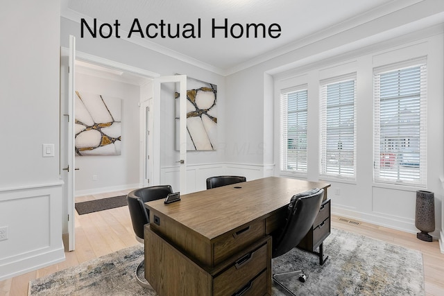 home office with light hardwood / wood-style flooring, plenty of natural light, and crown molding