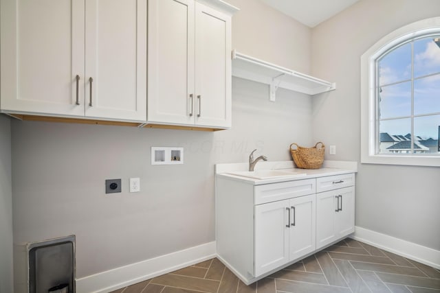 laundry room featuring cabinets, washer hookup, electric dryer hookup, and sink