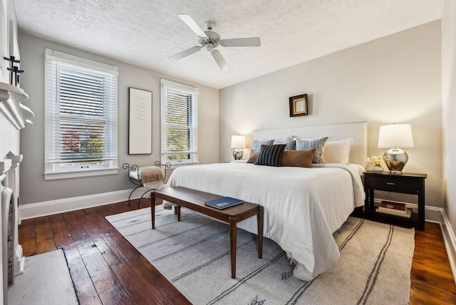 bedroom featuring ceiling fan, dark hardwood / wood-style flooring, and a textured ceiling