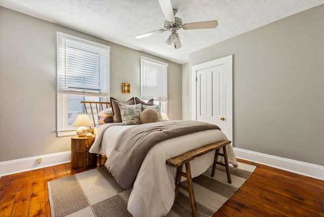 bedroom featuring wood-type flooring, a textured ceiling, a closet, and ceiling fan