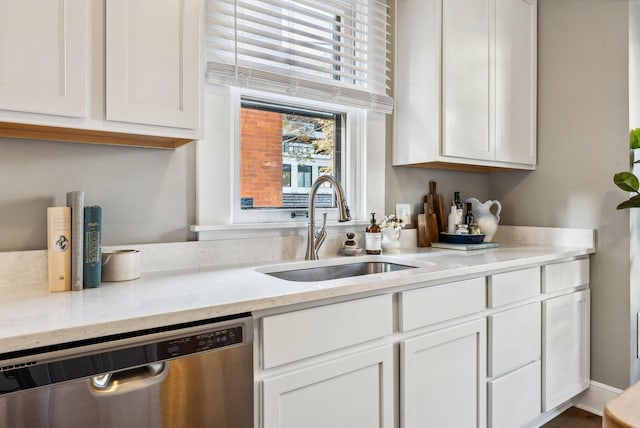 kitchen featuring white cabinetry, sink, and stainless steel dishwasher