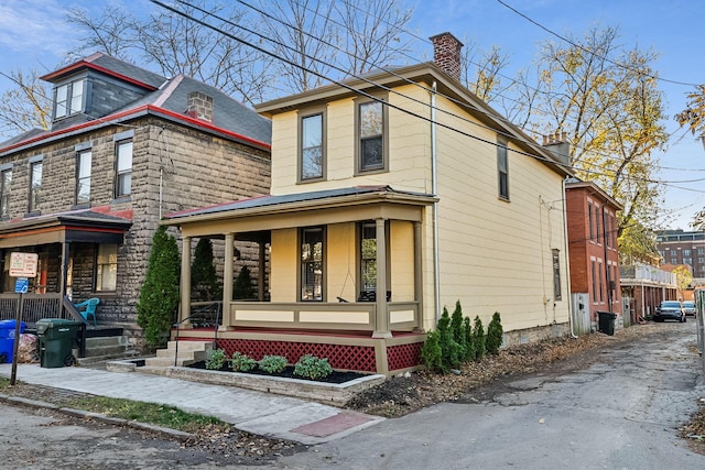 view of side of property with a porch