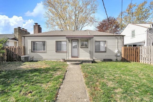 bungalow-style home with central AC and a front lawn