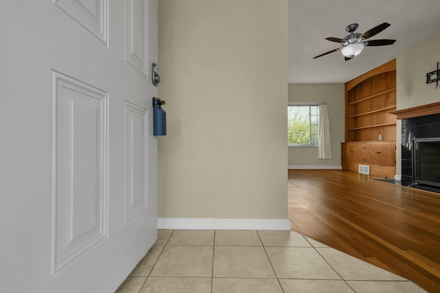 interior space with built in shelves and light hardwood / wood-style floors