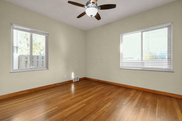 empty room featuring ceiling fan and wood-type flooring