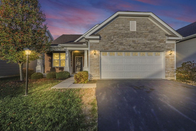 view of front of property with a lawn and a garage