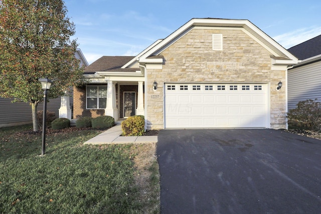 view of front facade with a front yard and a garage