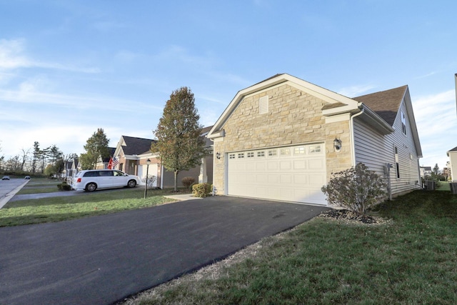 view of front of house featuring a garage and a front lawn