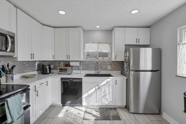 kitchen with sink, white cabinets, and black appliances