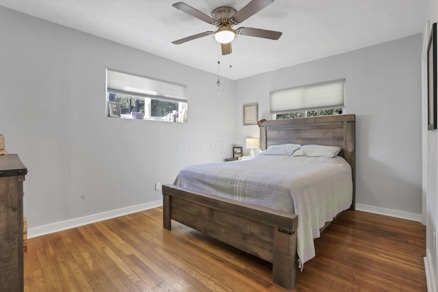 bedroom with ceiling fan and dark hardwood / wood-style flooring