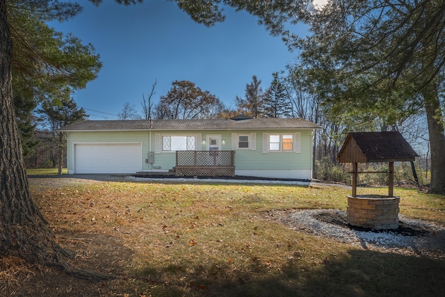 ranch-style house featuring a garage and a front lawn