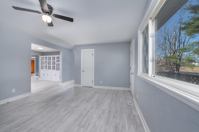 unfurnished living room with ceiling fan and light hardwood / wood-style flooring