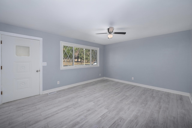 empty room featuring ceiling fan and light wood-type flooring