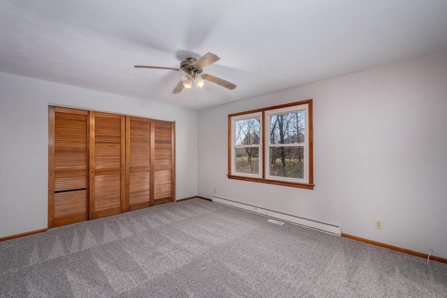 unfurnished bedroom featuring carpet flooring, ceiling fan, baseboard heating, and a closet