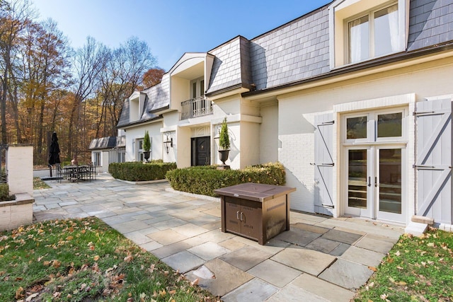 exterior space featuring a balcony and french doors