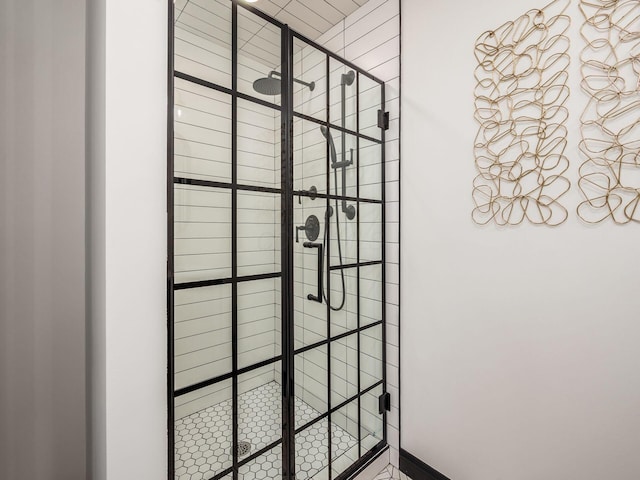 interior details featuring tiled shower