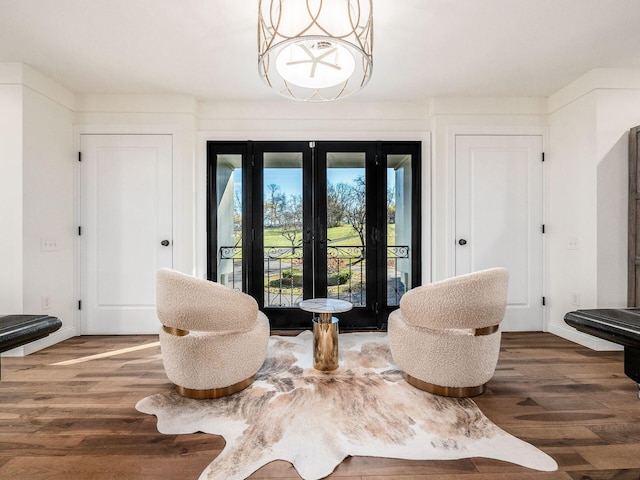 sitting room featuring french doors and dark wood-type flooring