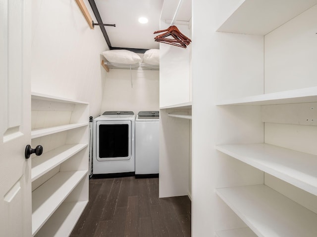 laundry room with washer and dryer and dark hardwood / wood-style flooring