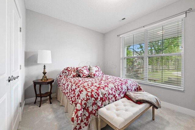 bedroom featuring light colored carpet