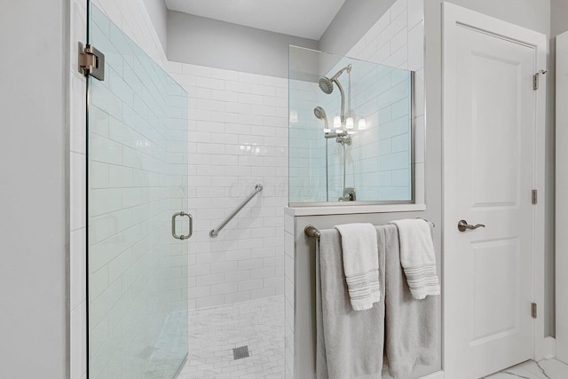 bathroom featuring a shower with shower door