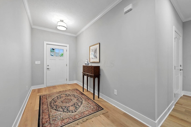 entrance foyer with crown molding, wood-type flooring, and a textured ceiling