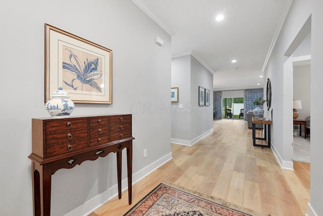 hallway featuring ornamental molding and light wood-type flooring