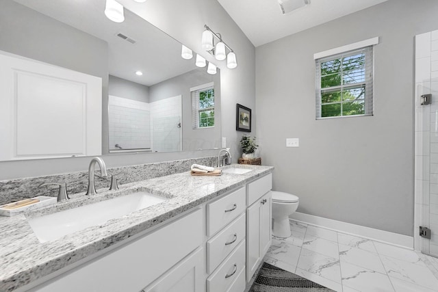 bathroom featuring vanity, toilet, and a shower with door