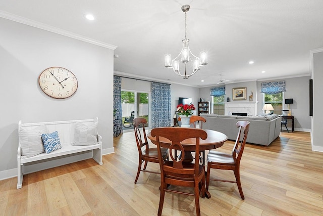 dining area featuring plenty of natural light, ornamental molding, and light hardwood / wood-style flooring