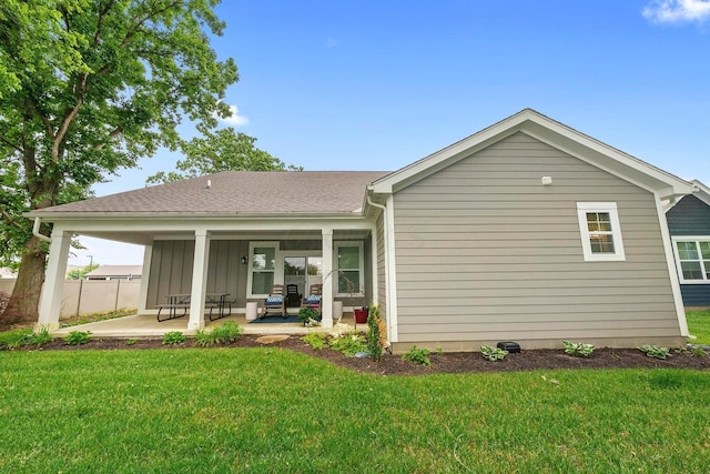 rear view of property with a patio area and a yard