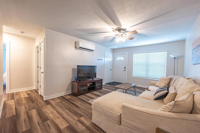 living room featuring a textured ceiling, ceiling fan, dark wood-type flooring, and a wall mounted AC