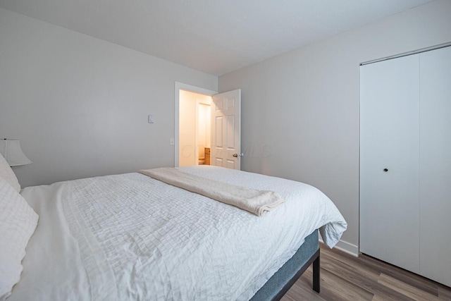 bedroom with hardwood / wood-style floors and a closet