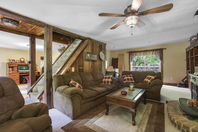 living room with a ceiling fan, carpet flooring, and stairs