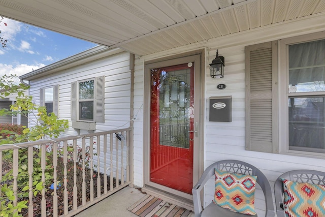 view of exterior entry featuring covered porch