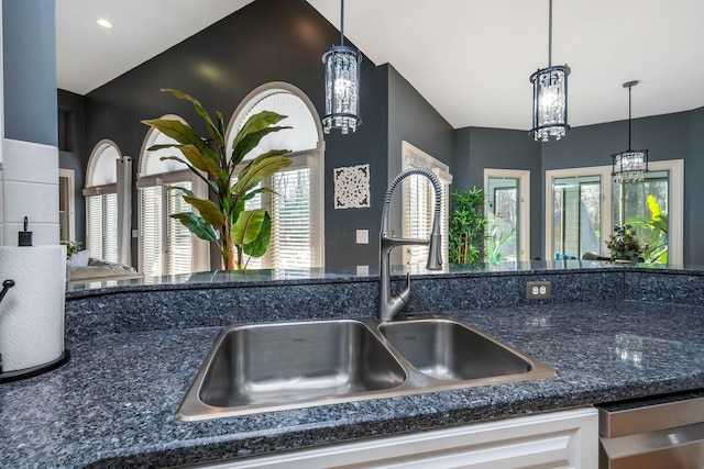 details featuring pendant lighting, sink, stainless steel dishwasher, a notable chandelier, and white cabinetry