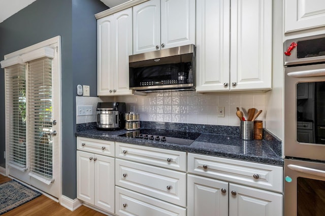 kitchen featuring white cabinetry, light hardwood / wood-style flooring, and appliances with stainless steel finishes